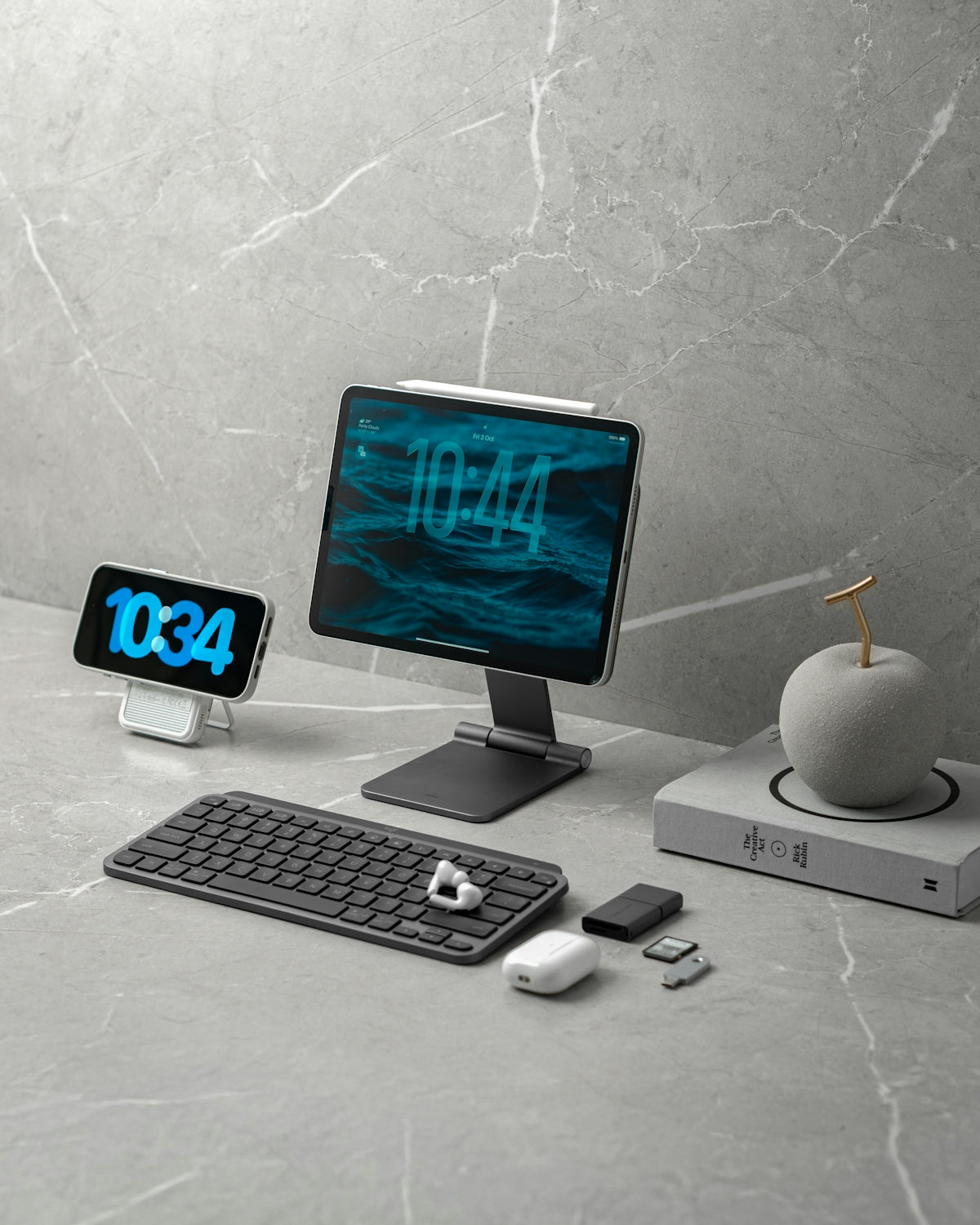 Digital devices and accessories on a marble desk.