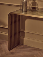 Matte Gold Slatted Console Table with Clear Glass Top | Vogue